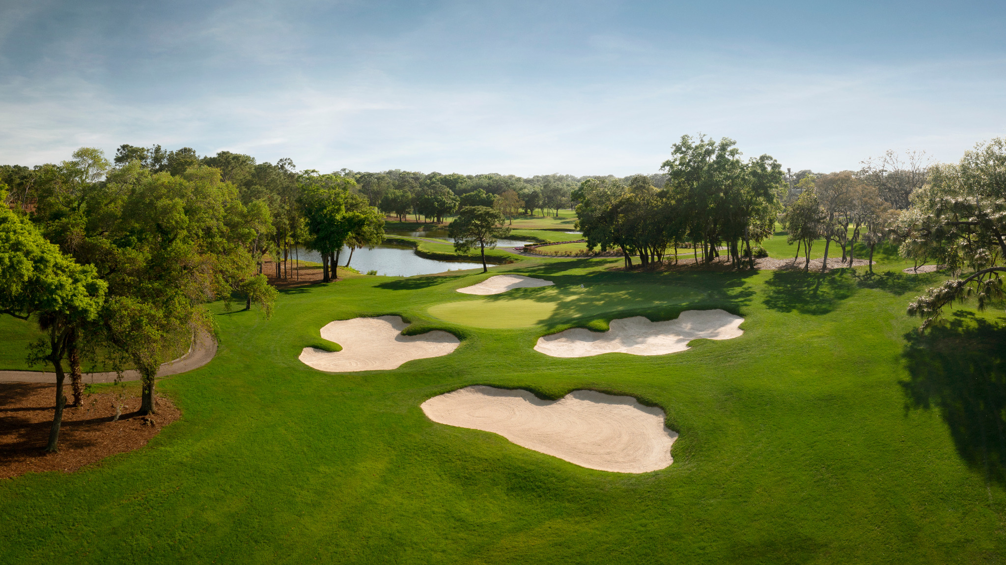 Aerial view of an Innisbrook golf course with bunkers, water and tree-lined fairways